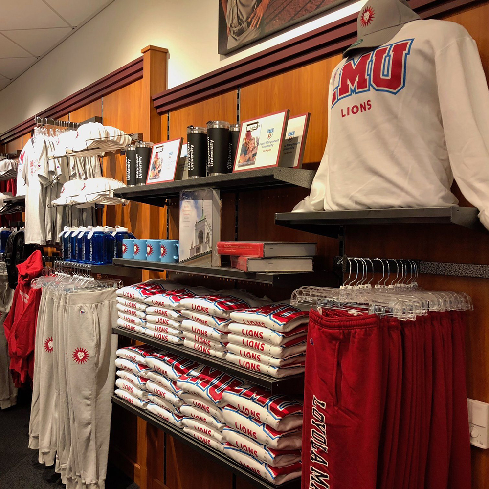A wall inside the LMU Bookstore displaying merchandise including clothing, pictures frames and mugs.